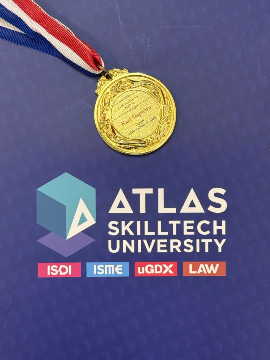 Chancellor's Medal engraved 'Karl Sequeira, Topper, uGDX Class of 2026', on an Atlas SkillTech University folder